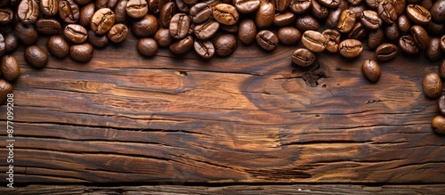 Wooden background with coffee beans; includes copy space image. photo