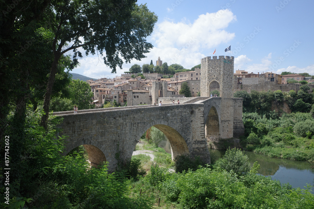 Girona, Spain - 7 July, 2024: The medieval Pont Vell bridge crossing the River Fluvia at Besalu, Catalonia Girona, Spain - 7 July, 2024: The medieval Pont Vell bridge crossing the River Fluvia at Besalu, Catalonia