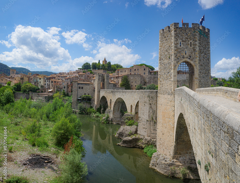 Girona, Spain - 7 July, 2024: The medieval Pont Vell bridge crossing the River Fluvia at Besalu, Catalonia Girona, Spain - 7 July, 2024: The medieval Pont Vell bridge crossing the River Fluvia at Besalu, Catalonia