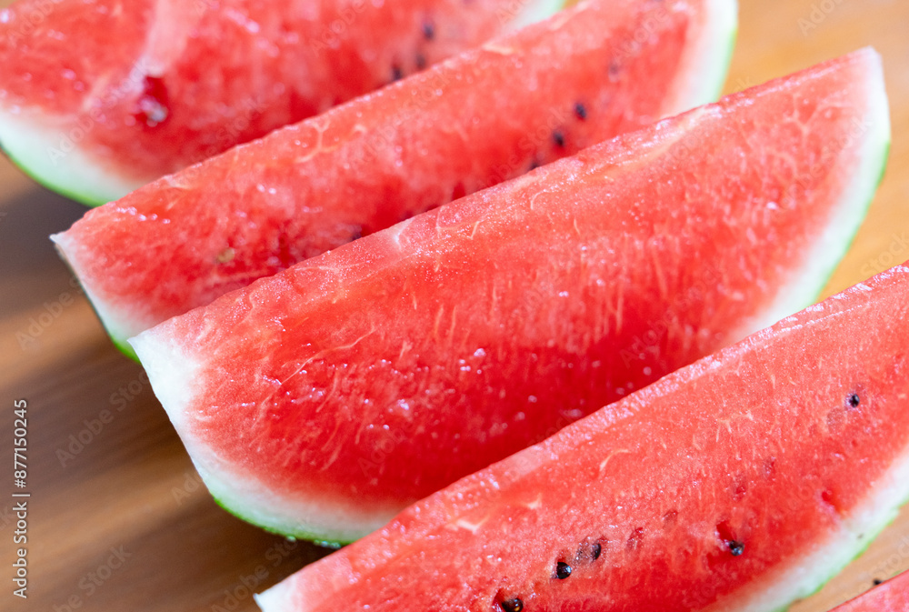 Watermelon slices closeup. Water melon wedges pile, Citrullus lanatus pieces, red wassermelone cuts group Watermelon slices closeup. Water melon wedges pile, Citrullus lanatus pieces, red wassermelone cuts group