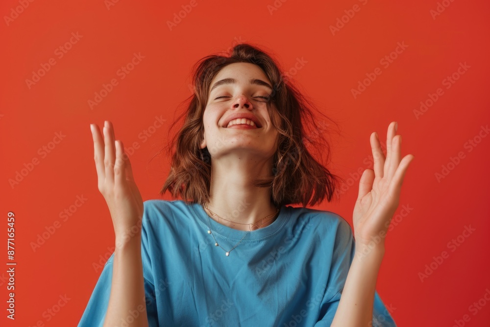 A woman stands with her arms raised, conveying surrender or defeat A woman stands with her arms raised, conveying surrender or defeat