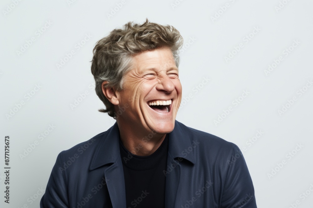 Portrait of a senior man laughing against a grey background with copy space Portrait of a senior man laughing against a grey background with copy space
