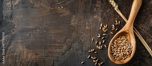 A wooden spoon with wheat g...