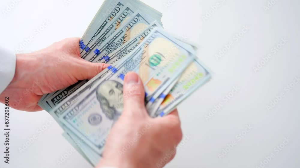 Male hands counting US Dollar bills, close-up Male hands counting US Dollar bills, close-up