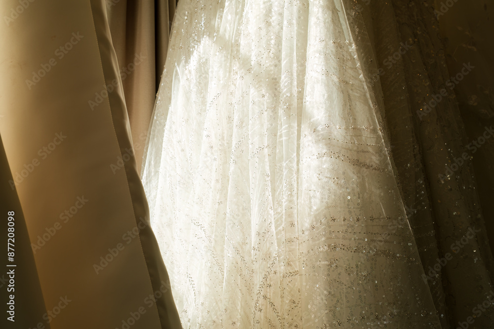 White wedding dress and different styles hanging in the sunlight White wedding dress and different styles hanging in the sunlight