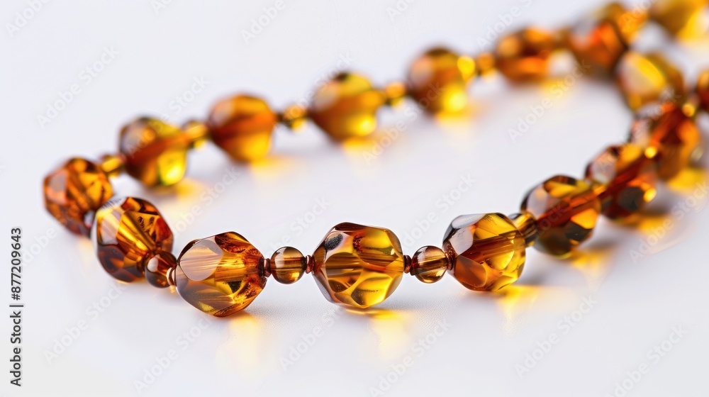 Amber chain from the Baltic region on a white backdrop Amber chain from the Baltic region on a white backdrop