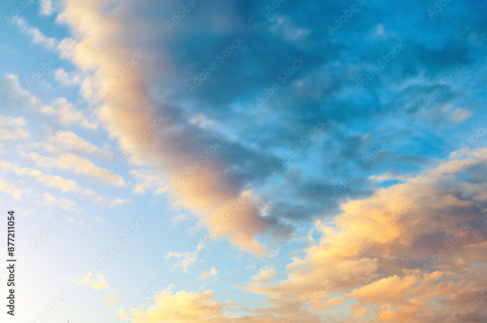 Obraz premium Sunset sky background. Picturesque colorful clouds lit by sunlight
