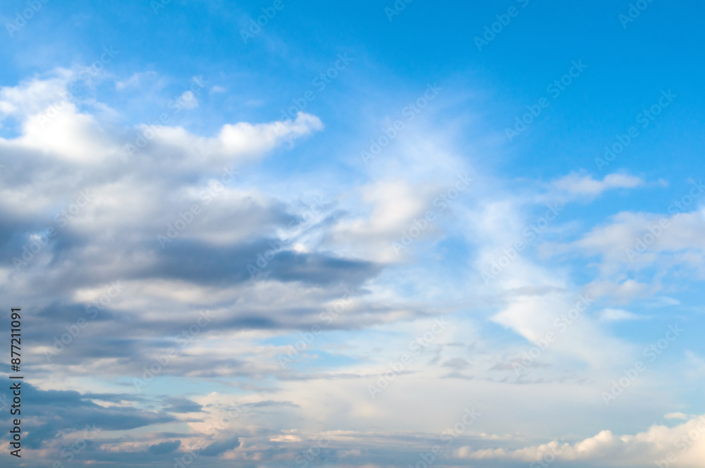 Blue sky landscape with dramatic colorful clouds and soft sunlight