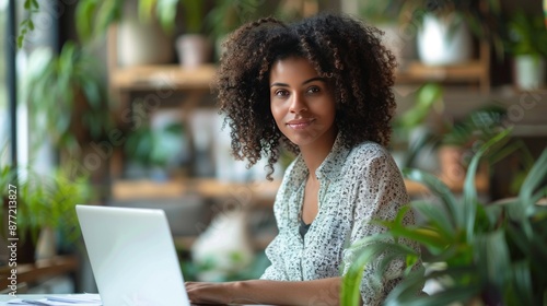 Smiling Woman Working on Laptop in a Cafe