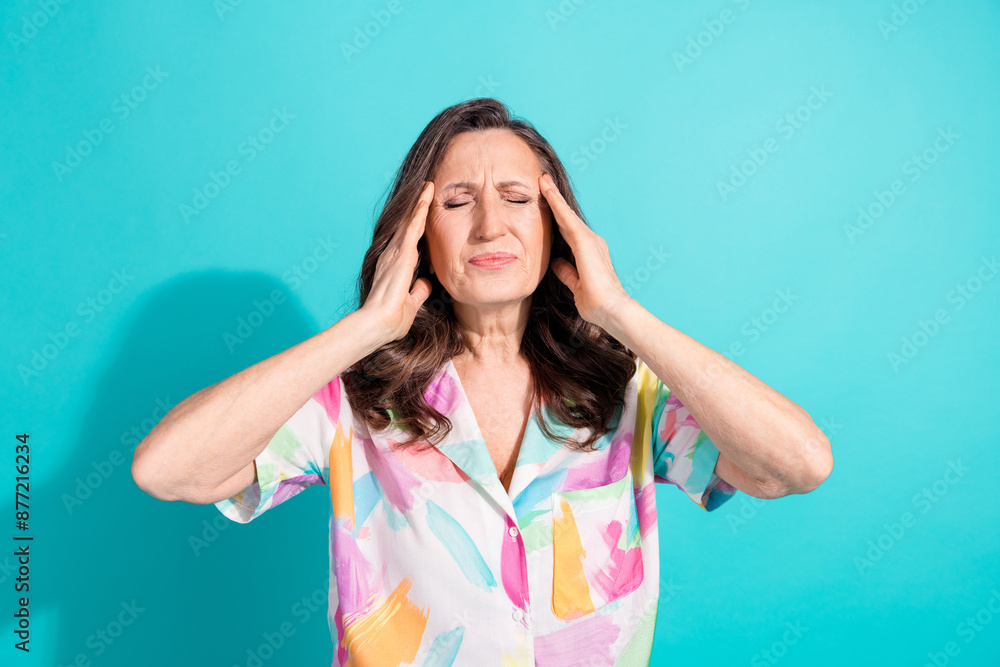 Photo portrait of lovely pensioner lady touch temples headache dressed stylish colorful garment isolated on cyan color background Photo portrait of lovely pensioner lady touch temples headache dressed stylish colorful garment isolated on cyan color background