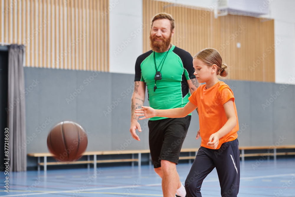 A man and a little girl are enjoying a game of basketball together. A man and a little girl are enjoying a game of basketball together.