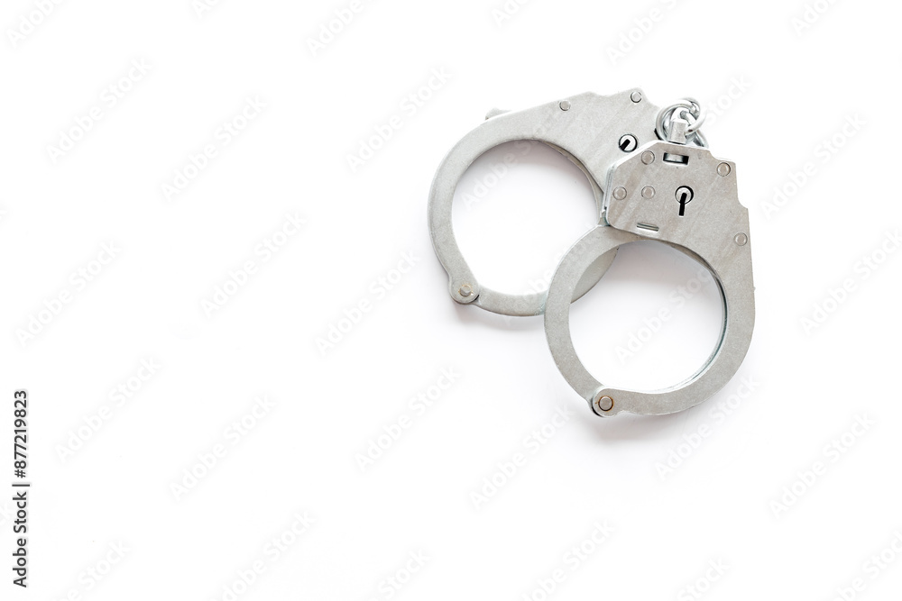 Close up police metal handcuffs, top view. Criminal law and justice concept Close up police metal handcuffs, top view. Criminal law and justice concept