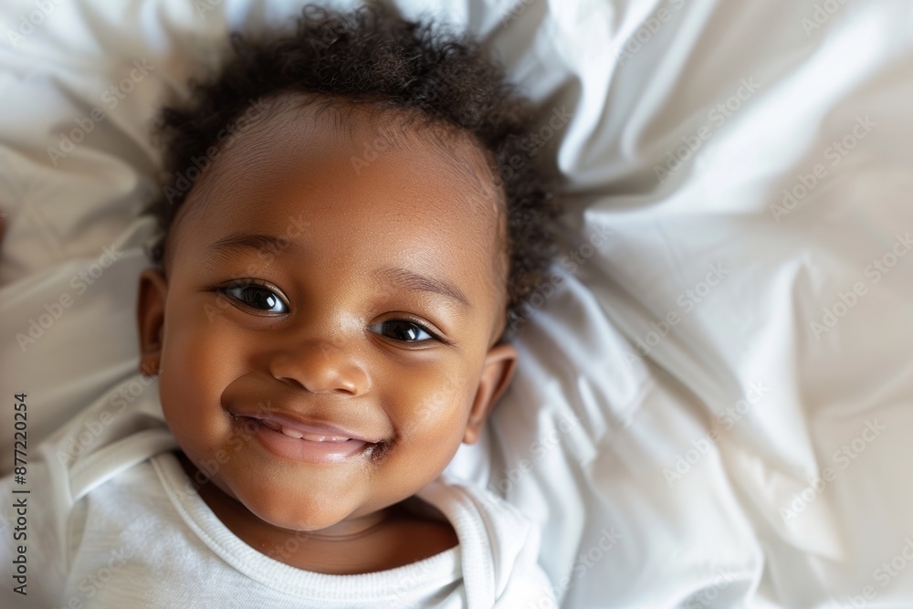 Top view of a cheerful toddler african american baby boy lying on bed. Top view of a cheerful toddler african american baby boy lying on bed.