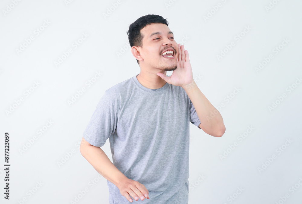 Young happy asian man announcing information with hands cup around mouth isolated on white studio background. advertising concepts Young happy asian man announcing information with hands cup around mouth isolated on white studio background. advertising concepts