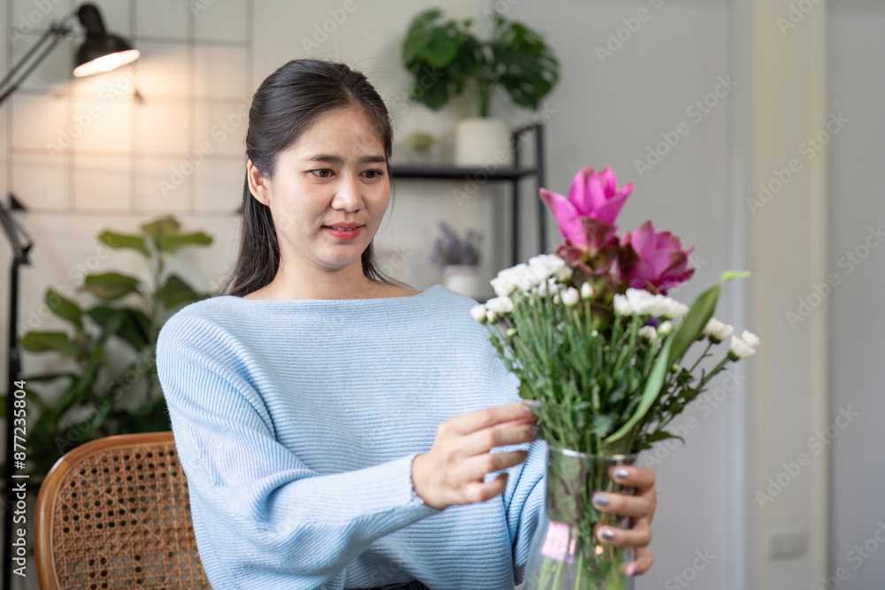 Woman Arranging Fresh Flowers in a Vase at Home with Modern Interior Design Woman Arranging Fresh Flowers in a Vase at Home with Modern Interior Design