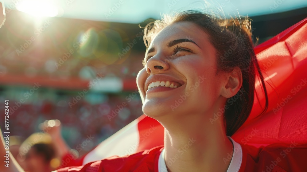 Φωτογραφία Cheerful young female fan in red shirt smiling and looking up at stadium