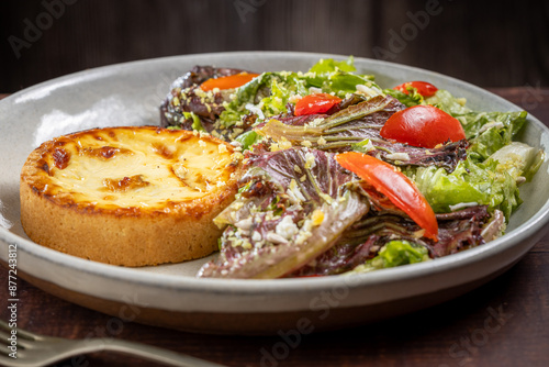 Quiche with lettuce and tomato salad. Healthy food.