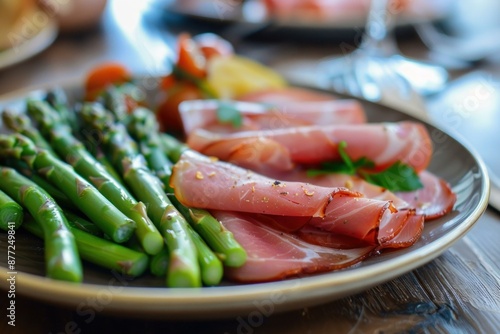 Gourmet italian prosciuttowrapped asparagus appetizer on a fine ceramic plate for elegant dining. Featuring fresh green vegetables and savory cured meat photo