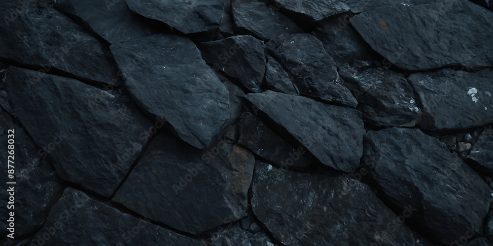 Textured dark stone wall with irregular shapes and rough edges. Ideal for backgrounds, textures, or construction-themed projects. Textured dark stone wall with irregular shapes and rough edges. Ideal for backgrounds, textures, or construction-themed projects.