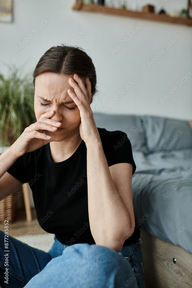 Middle-aged woman in distress, hands on face, sitting on floor. Middle-aged woman in distress, hands on face, sitting on floor.