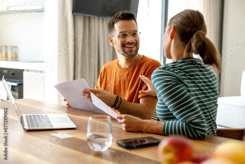 Young couple using laptop at home
