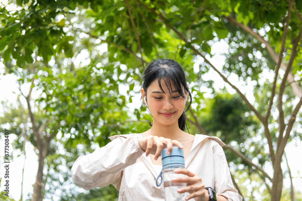 Young woman holding water bottle to drink. Young woman holding water bottle to drink.
