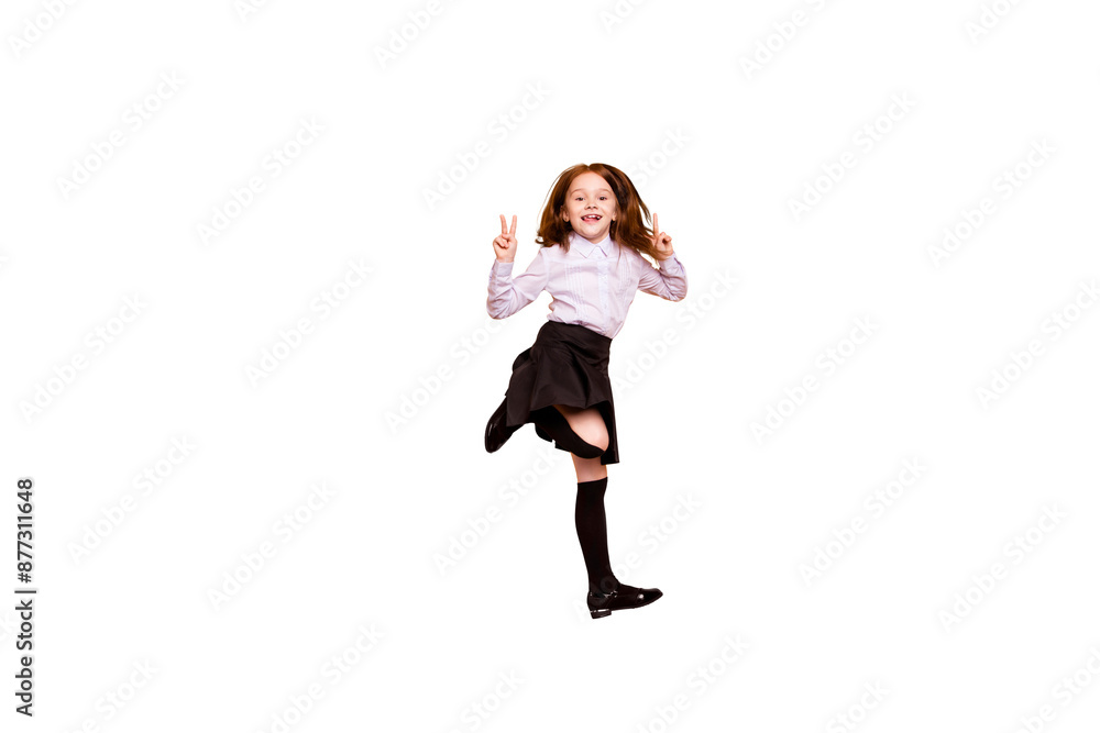 Full size photo of lovely kid make v-signs jumping have skirt long socks white blouse isolated beige background Full size photo of lovely kid make v-signs jumping have skirt long socks white blouse isolated beige background
