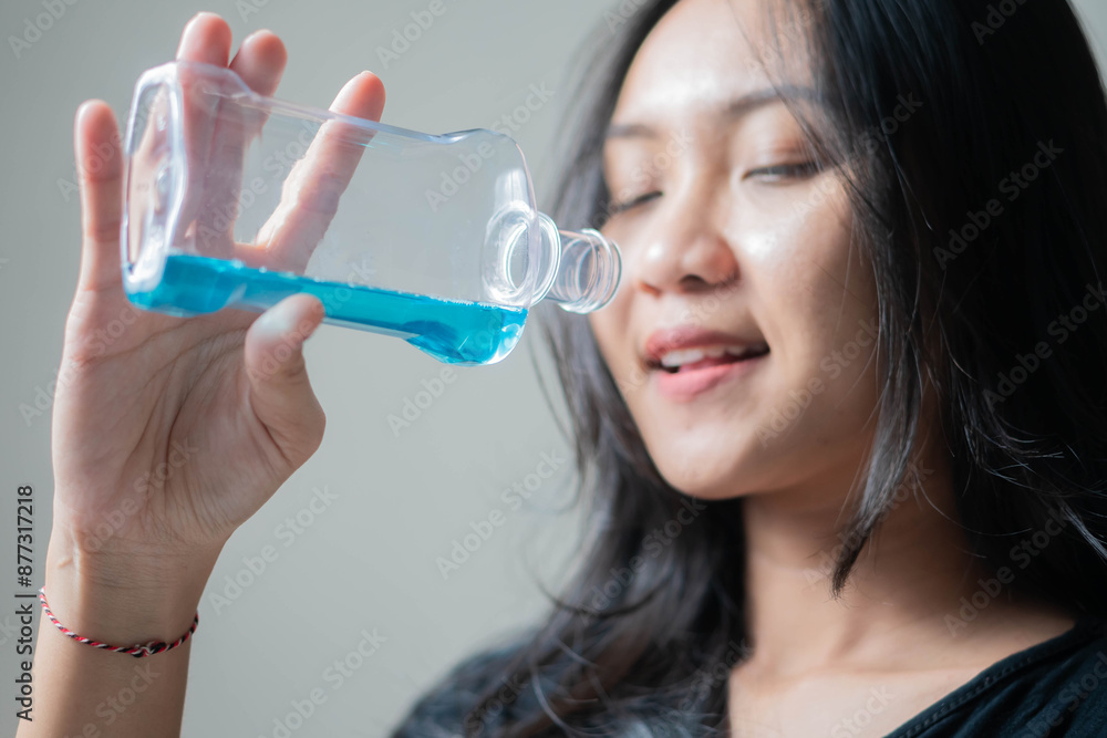 Woman holding a bottle with blue liquid Woman holding a bottle with blue liquid