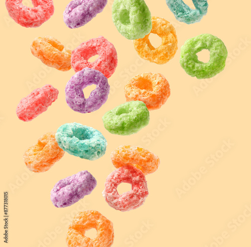 Creative layout made of colorful corn rings on the yellow background. Food concept. Macro concept. Breakfast cereals on the white.