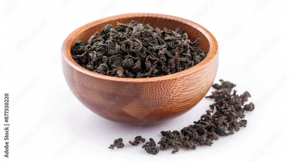 Chinese oolong tea in a wooden bowl on a white background Chinese oolong tea in a wooden bowl on a white background