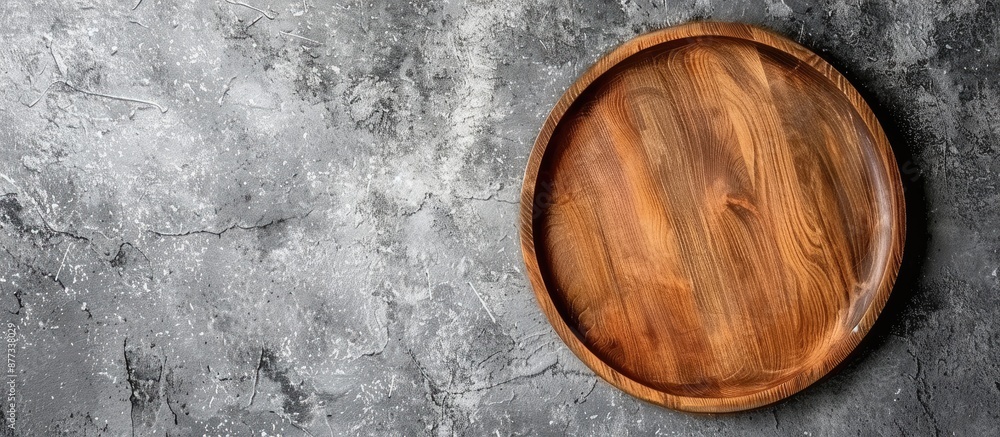 Wooden plate on cement background with space for text or images ideal for food display or mockups in top view perspective. Copy space image. Place for adding text and design Wooden plate on cement background with space for text or images ideal for food display or mockups in top view perspective. Copy space image. Place for adding text and design