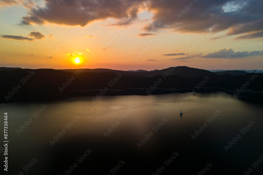 Beautiful aerial view of a lake at sunset, nature. sunset is viewed over a lake with the distant mountain range in silhouette. Beautiful aerial view of a lake at sunset, nature. sunset is viewed over a lake with the distant mountain range in silhouette.