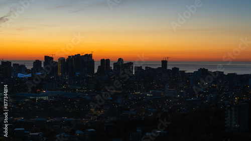 Panoramic view of Batumi with lights and the sea from the top of the cable car on the mountain at dusk at sunset. Stunning view of the city of Batumi.