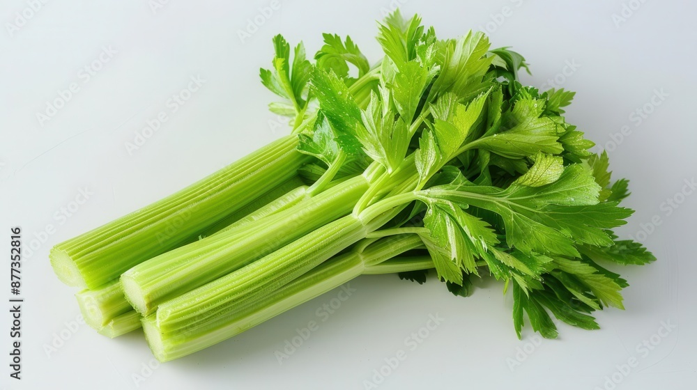 Fresh celery stalks, crisp and green, isolated white background, copy space Fresh celery stalks, crisp and green, isolated white background, copy space