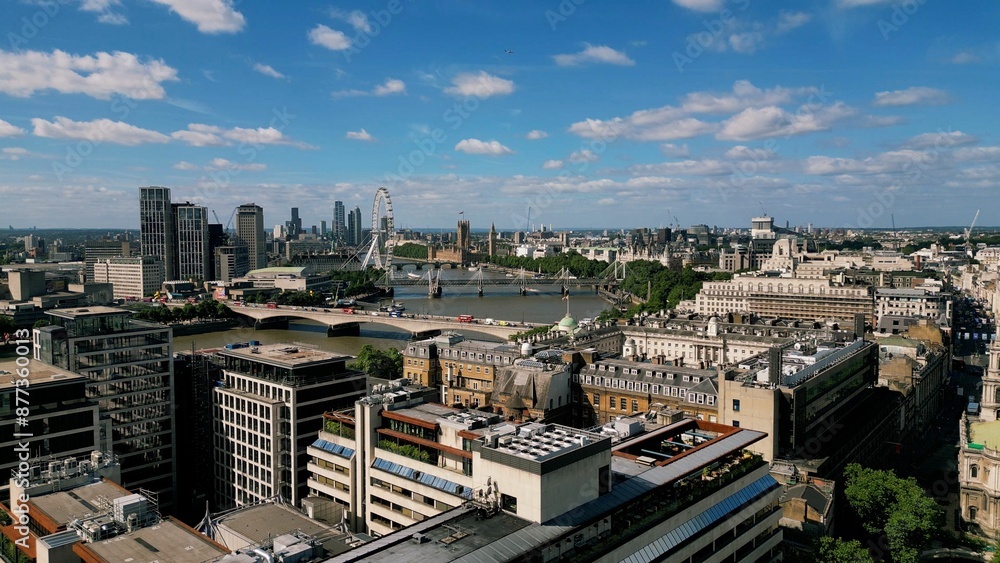 Fototapeta premium Drone image of the London Skyline featuring clear blue sky with a few clouds