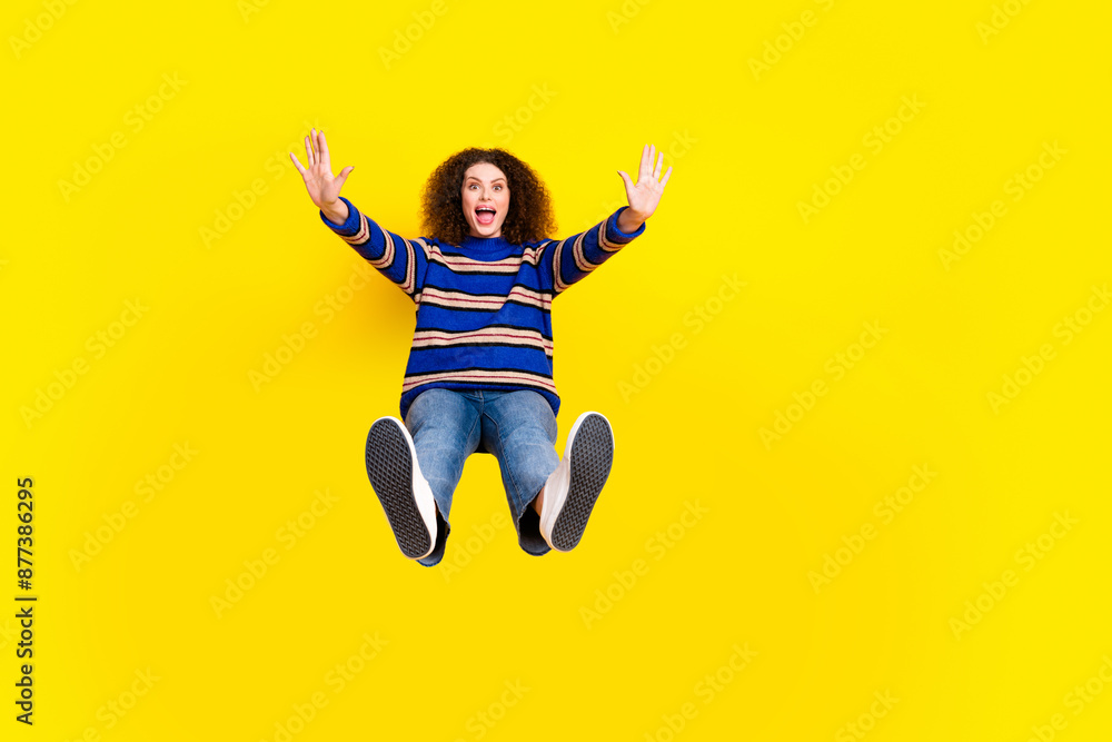 Obraz premium Full length photo of astonished girl dressed knit sweater falling from platform raising palms scream isolated on yellow color background