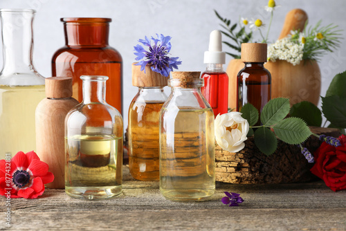 Wallpaper Mural Aromatherapy. Different essential oils, flowers and green leaves on wooden table Torontodigital.ca