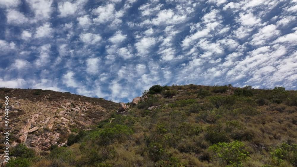 Aerial view of the hill sides of Mission Trails Cowles Mountain on a partly cloudy day with small puffy clouds in San Diego California Aerial view of the hill sides of Mission Trails Cowles Mountain on a partly cloudy day with small puffy clouds in San Diego California