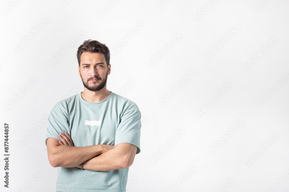 Bearded handsome man standing on white background in confident crossed arms position Bearded handsome man standing on white background in confident crossed arms position