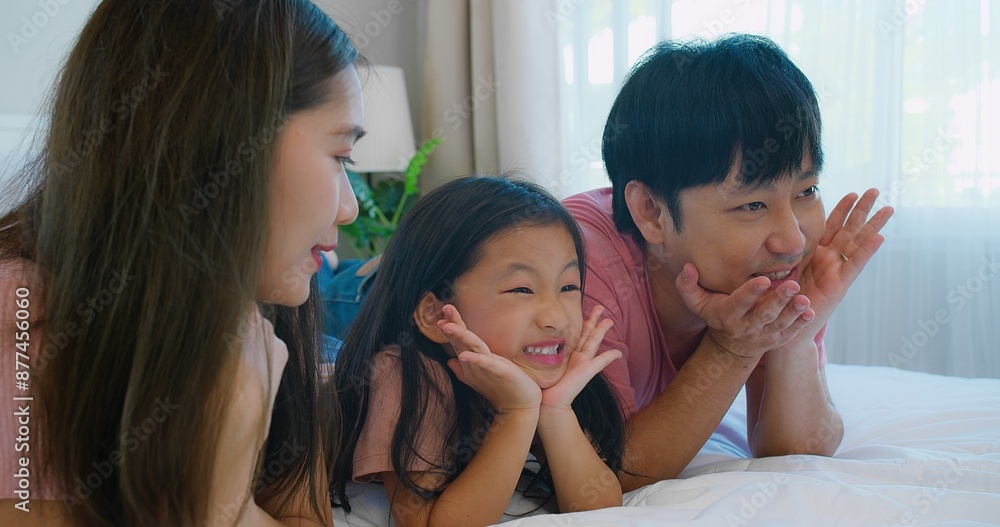 A joyful moment Asian family parents and child spending quality time together on a bed with a smiling in cozy bedroom, showcasing love and togetherness capturing the essence of family bonding. A joyful moment Asian family parents and child spending quality time together on a bed with a smiling in cozy bedroom, showcasing love and togetherness capturing the essence of family bonding.
