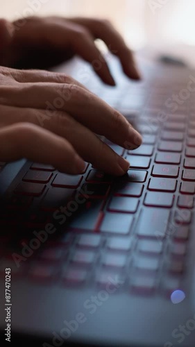 men's hands working on a laptop keyboard