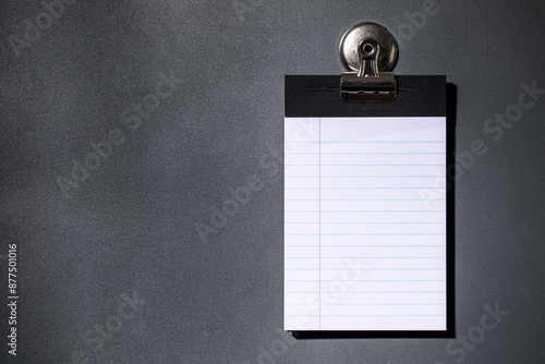 Lined note paper on dark gray magnet board