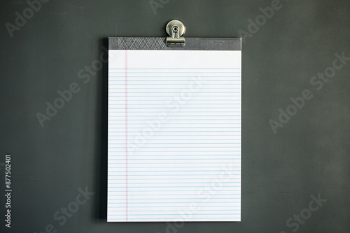 Lined note paper on dark gray magnet board