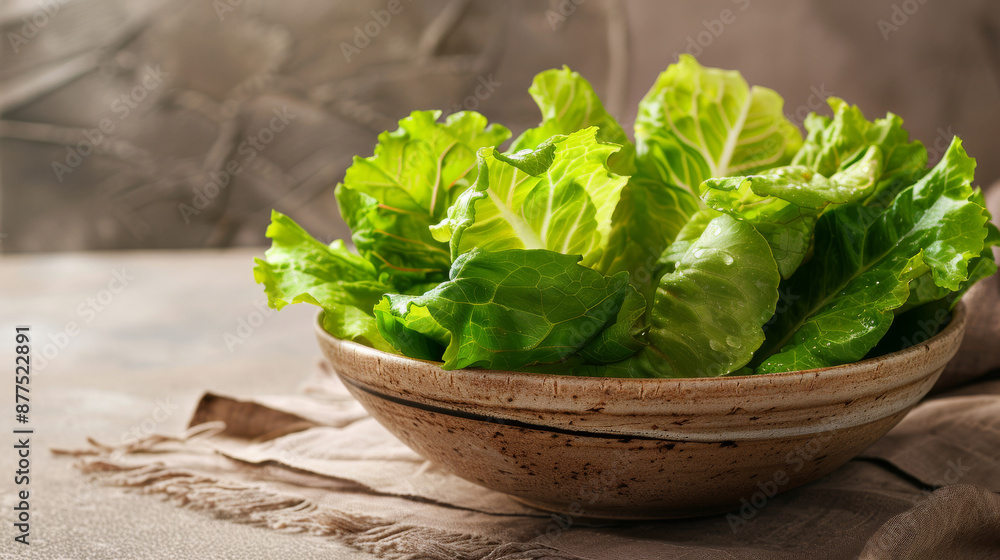 A rustic ceramic bowl filled with fresh, leafy green lettuce on a table, representing healthiness and organic living in a warm, cozy kitchen environment. A rustic ceramic bowl filled with fresh, leafy green lettuce on a table, representing healthiness and organic living in a warm, cozy kitchen environment.