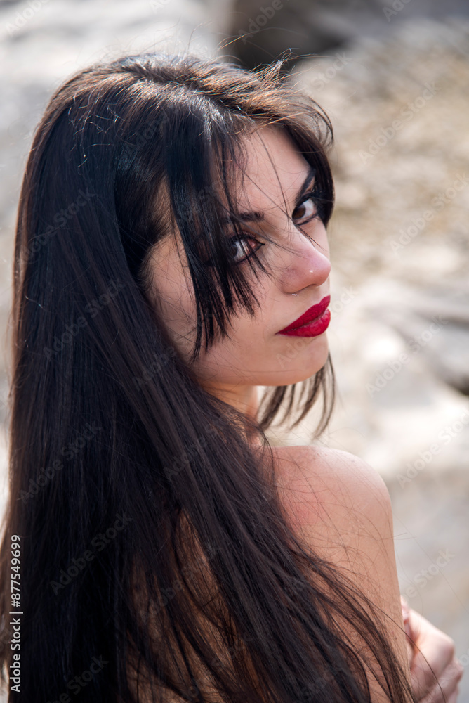 Fototapeta premium Brunette model with long hair posing on beach