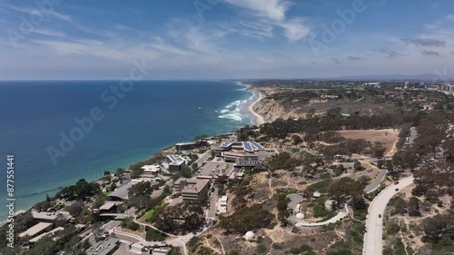 Aerial view of paragliders flying over La Jolla with views of luxury homes along the cliffs and the Pacific Ocean by Scripps Research institute in San Diego on a sunny day photo