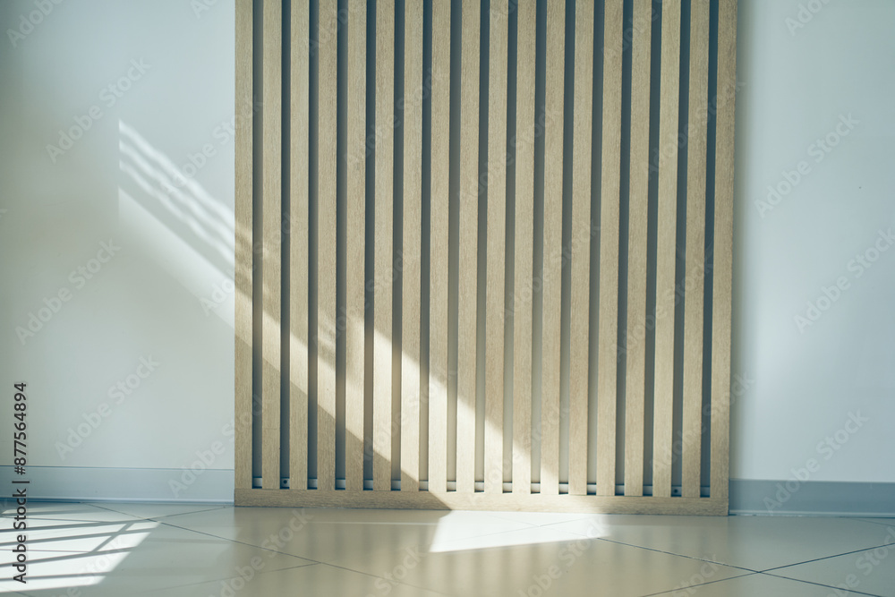 The room has a wall of wooden panels with space for copying. Light brown vertical boards on a light background. Fashionable interior with striped wooden elements. High quality photo The room has a wall of wooden panels with space for copying. Light brown vertical boards on a light background. Fashionable interior with striped wooden elements. High quality photo