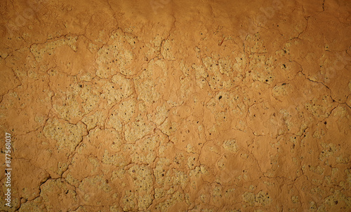 Wall of old mud house. Clay wall, surface texture. Close up. photo