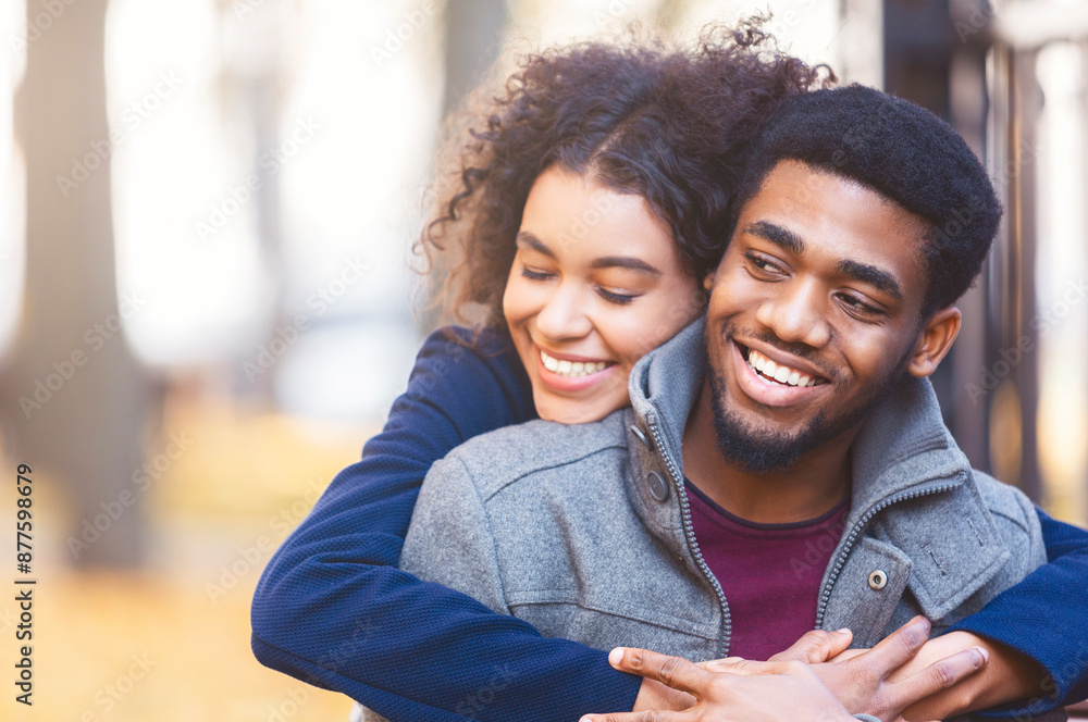 Lovely young black couple cuddling while date in autumn park, copy space Lovely young black couple cuddling while date in autumn park, copy space