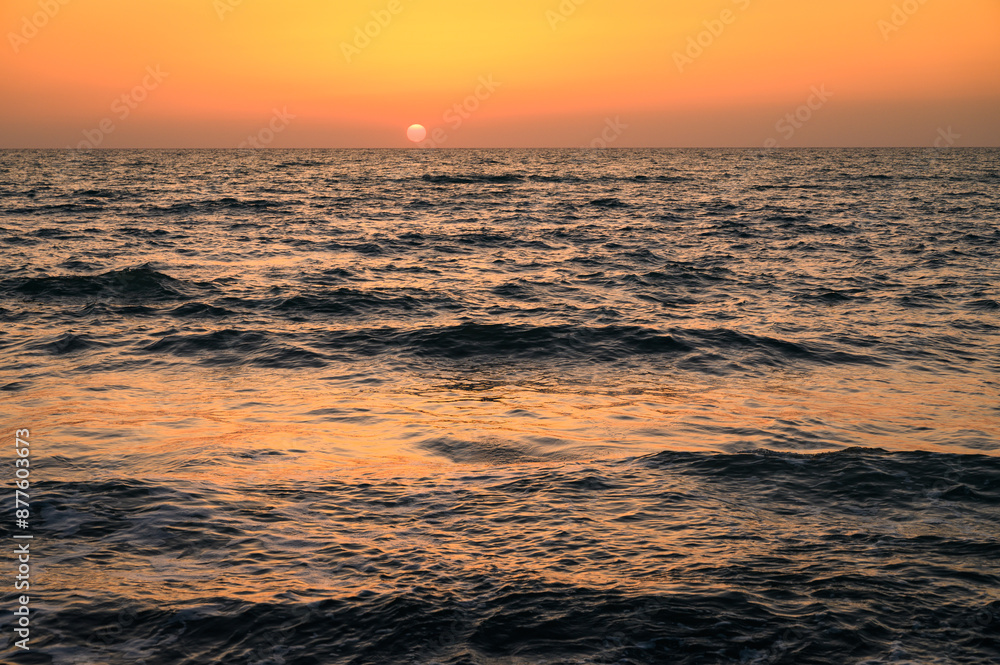the vibrant hues and reflections in the sky as the sun sets over the Mediterranean Sea the vibrant hues and reflections in the sky as the sun sets over the Mediterranean Sea